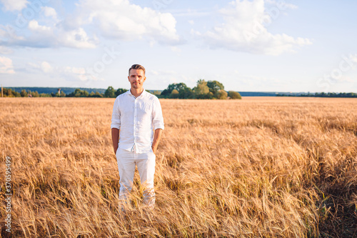 Happy tourist man in a wheat field © travnikovstudio