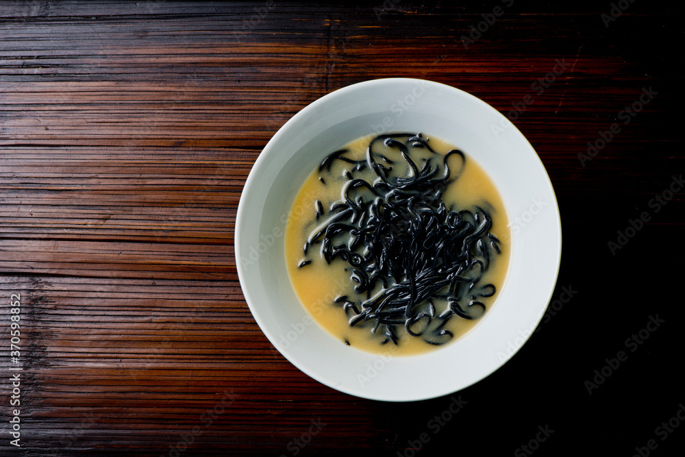 Ramen noodles. Japanese classic soup, with noodles, broth, pork, chicken, tofu, scallions, mushrooms, eggs and red pepper sauce. Copy space. Ramen noodles. Japanese classic soup, with noodles, broth, pork, chicken, tofu, scallions, mushrooms, eggs and red pepper sauce. Copy space.
