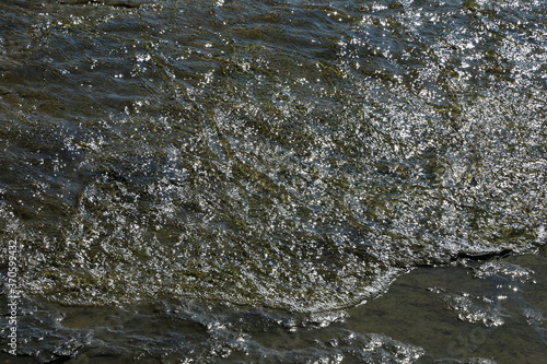 Clear water ripples with sunlight 