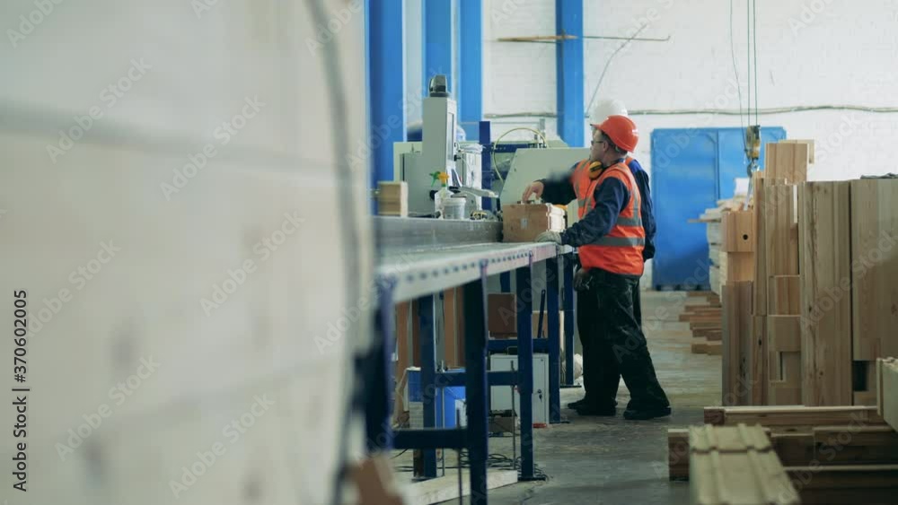 Two engineers work together at woodworking plant. Two engineers work together at woodworking plant.