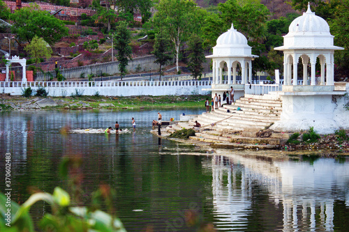 Udaipur, India: People by the lake located in Doodh Talai Musical Garden in Rajasthan state