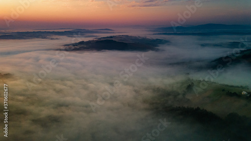 Polish Hillside and Mountains in Early Morning Fog. Aerial Drone View