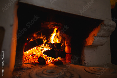 Fire hearth of russian oven in traditional village house.