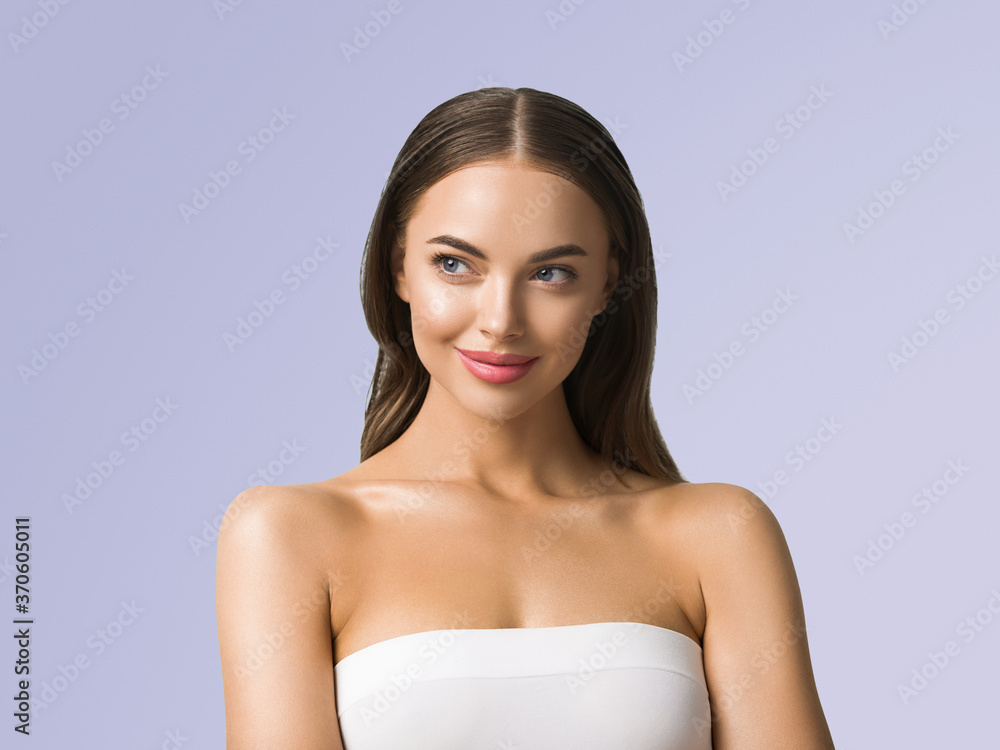 Clean skin beauty woman face healthy skin natural make up tanned female over blue background Clean skin beauty woman face healthy skin natural make up tanned female over blue background
