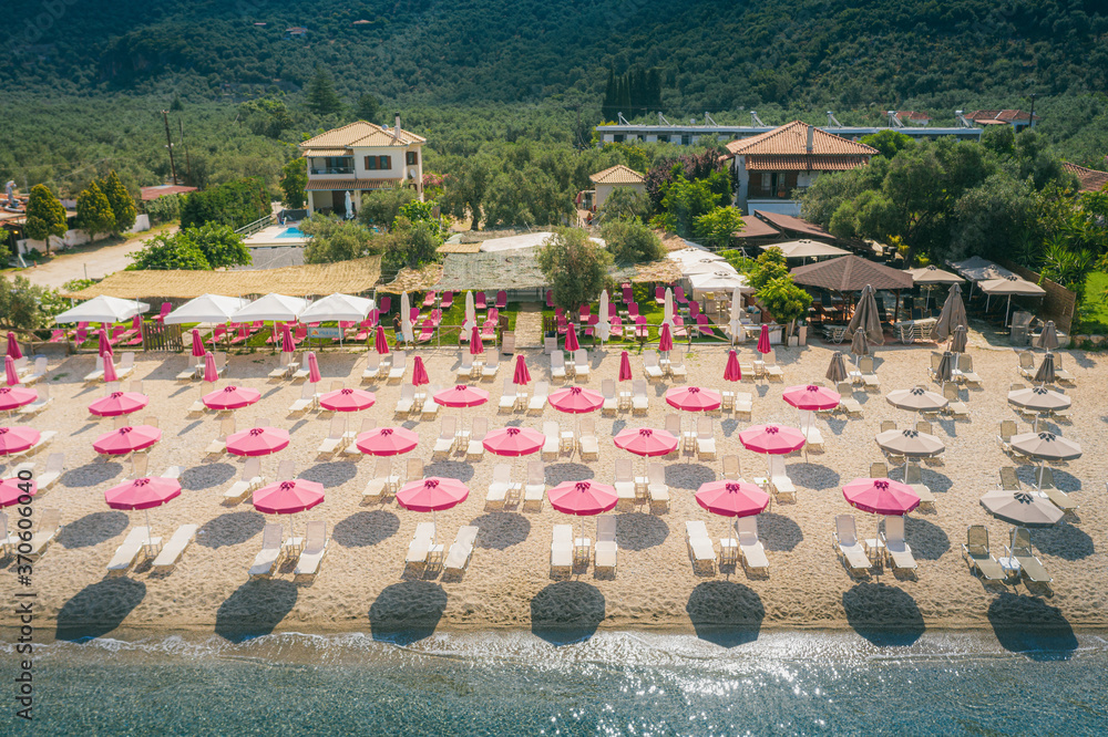 Fotografie Sun umbrellas at empty beach in Afissos, Greece