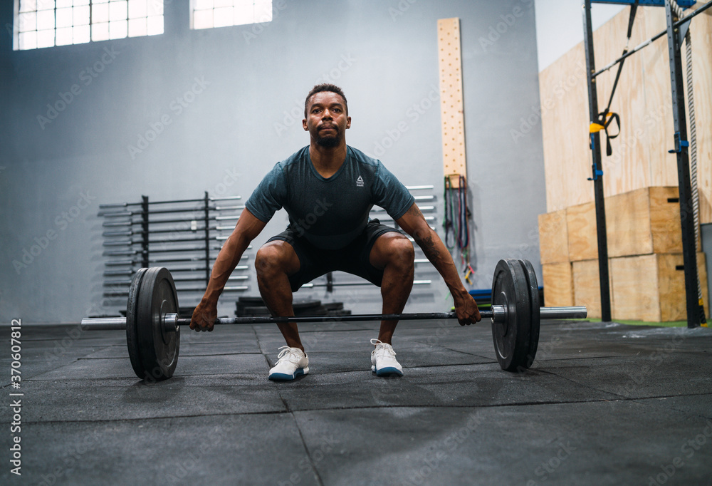 Crossfit athlete doing exercise with a barbell. Crossfit athlete doing exercise with a barbell.