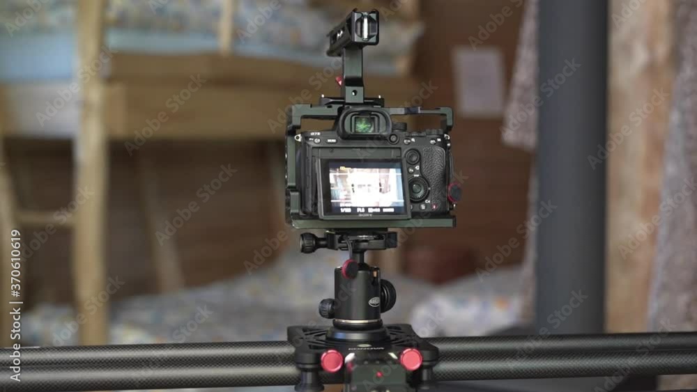 Slow rotating FHD shot of a slider camera set up in a window of a wooden cottage, taking shots of a rustical wooden bedroom with a bunk bed. Slider camera taking shots of a wooden house bedroom. Slow rotating FHD shot of a slider camera set up in a window of a wooden cottage, taking shots of a rustical wooden bedroom with a bunk bed. Slider camera taking shots of a wooden house bedroom.