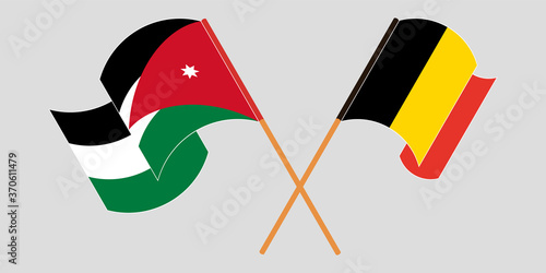 Crossed and waving flags of Jordan and Belgium