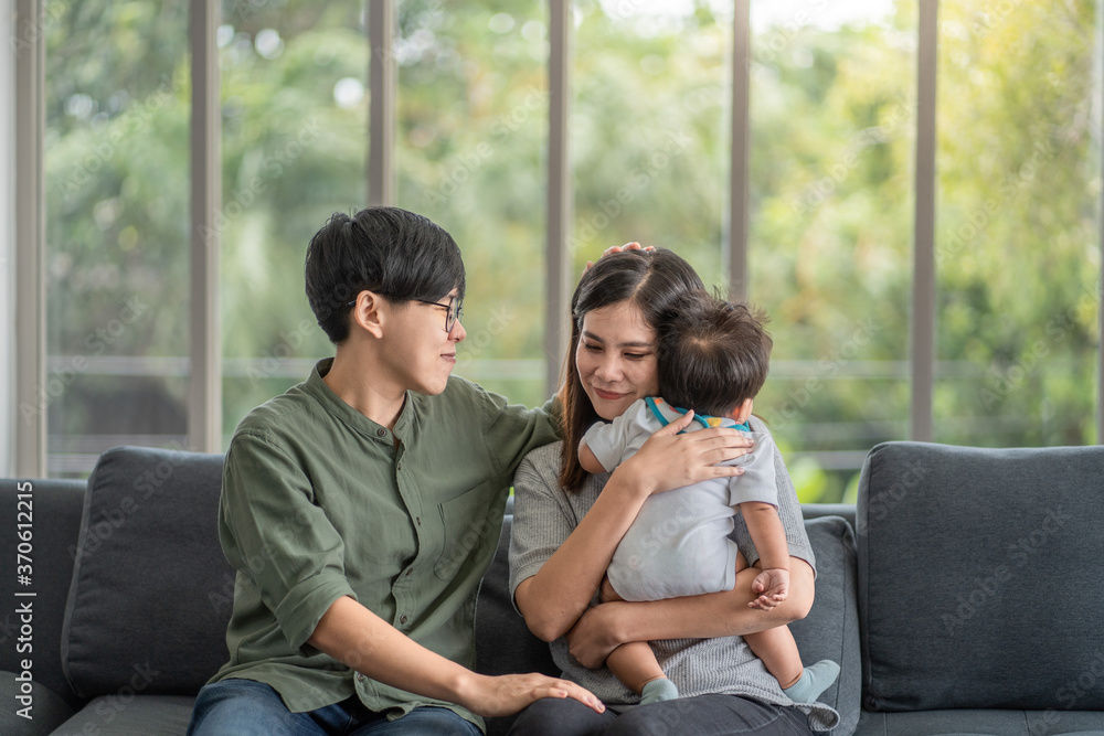 Diversity Lesbian sitting with cute toddler girl in between. Happiness and family bonding in LGBTQ family, LGBT lifestyle. Diversity Lesbian sitting with cute toddler girl in between. Happiness and family bonding in LGBTQ family, LGBT lifestyle.