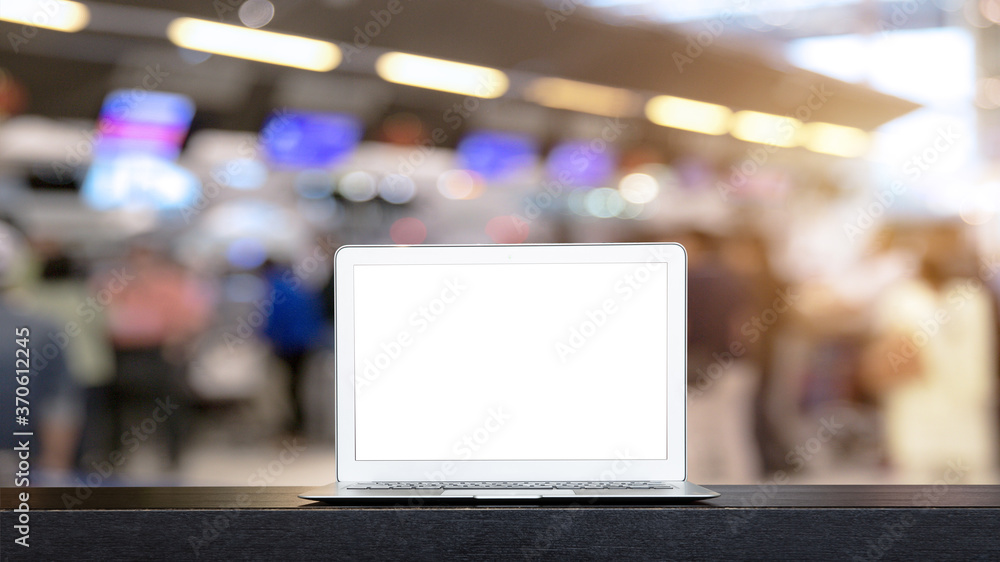 Laptop with blank screen on table work in airport, clipping path inside