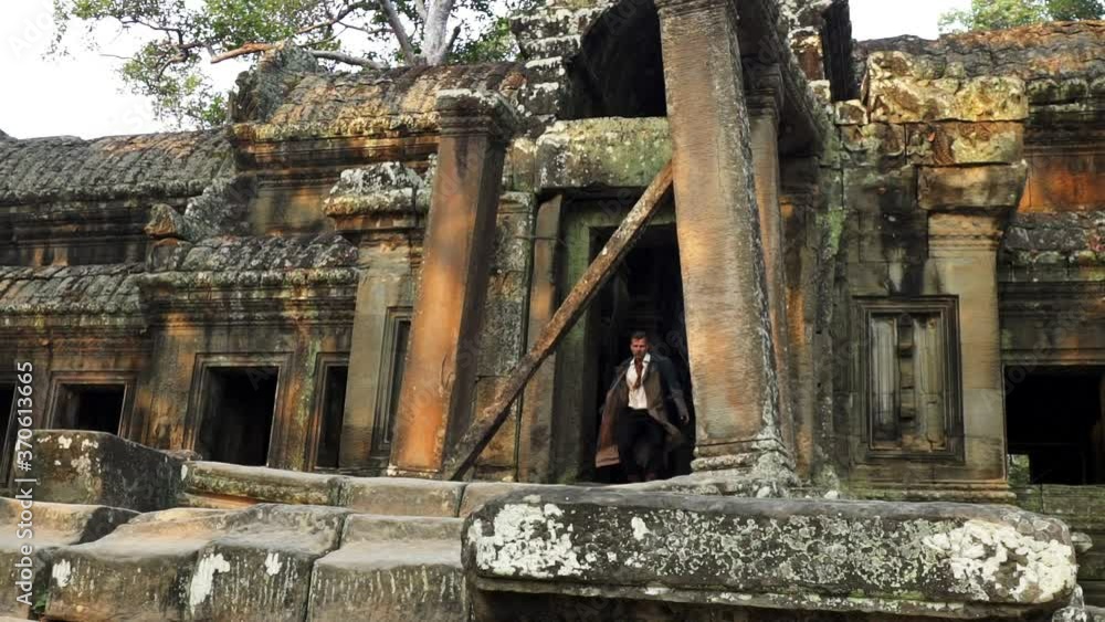 Slowmo Video of Man Running Out Coming from the Cambodian Temple Ruins Slowmo Video of Man Running Out Coming from the Cambodian Temple Ruins