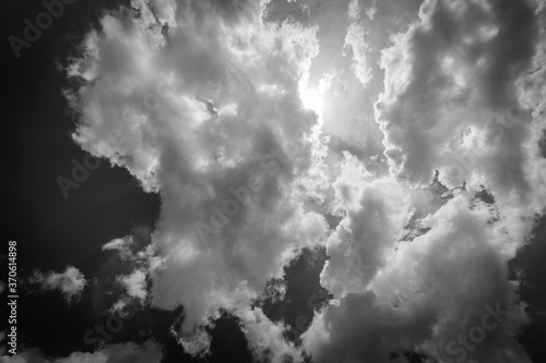 Dramatic black and white cirrus clouds against the blue sky. Monochrome sky background with clouds 