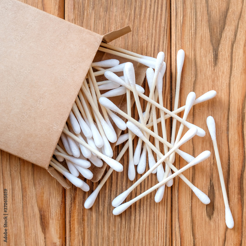 Eco-friendly cotton swabs. View from above. Square image. Wood background Eco-friendly cotton swabs. View from above. Square image. Wood background