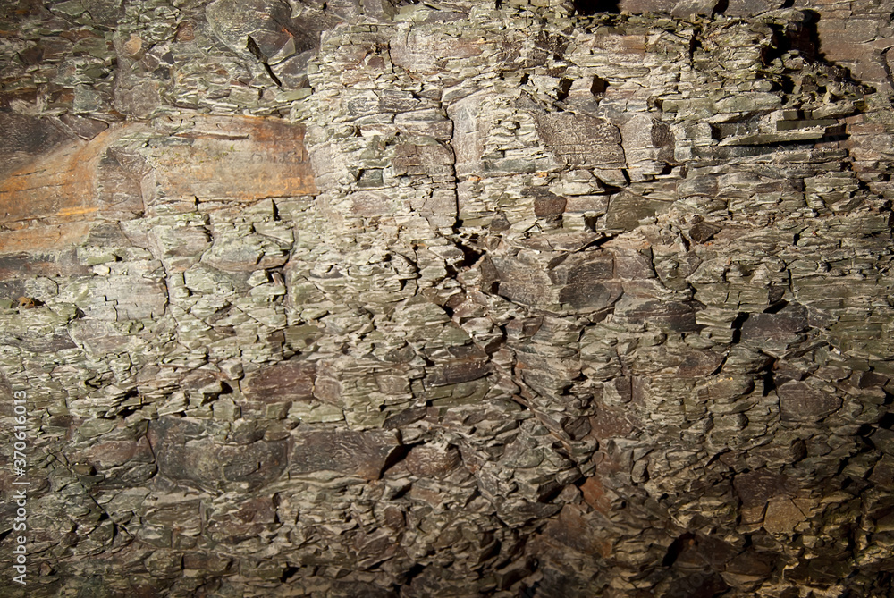 Stone texture close up. Rock with cracks and dirt. Lots of small stones and cracks in the rock.