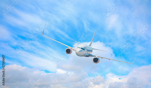 White passenger airplane in the clouds  - Travel by air transport