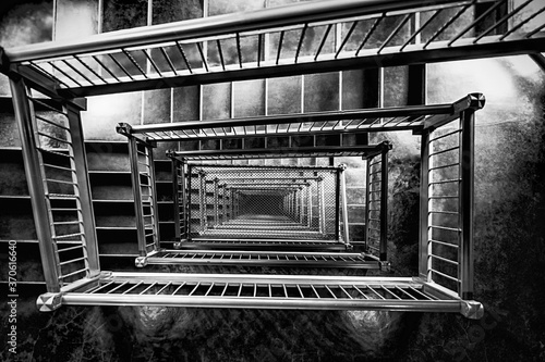 Stairway In Old Building Going Downward Around and Around In Black & White