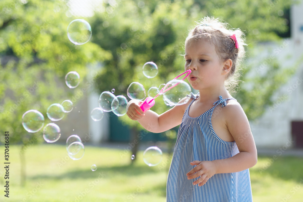 little girl blowing soap bubbles little girl blowing soap bubbles