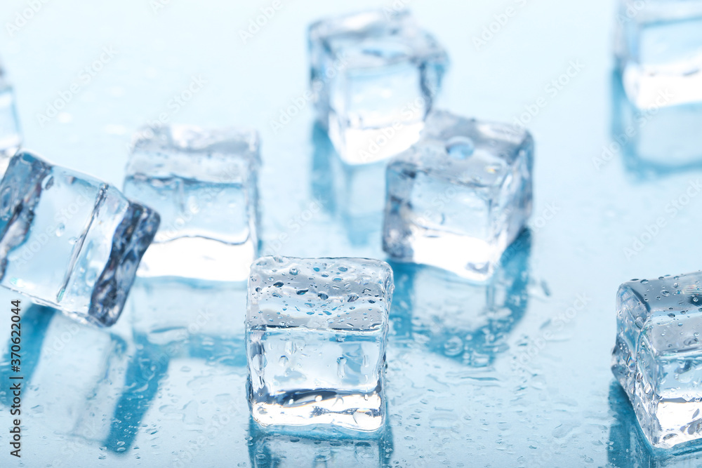 Ice cubes with water drops on blue background Ice cubes with water drops on blue background