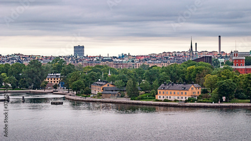 Panoramic view of different parts of Stockholm from the observation deck, cloudy summer day with blurry small fragments in the corners of the card