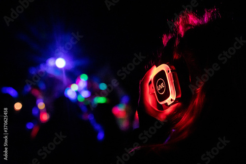 Silent Disco headphones Live at an event with a girl holding the headpones photo