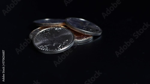 five gold dollar coins with a value of 10000 dollars lie on a turntable1 photo