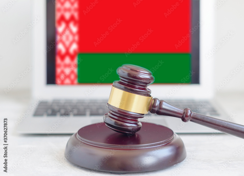 judge's gavel on the background of a laptop with the flag of Belarus