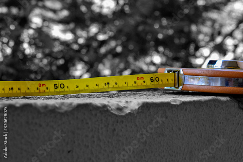 flexometer or meter on wall with black and white background and the flexometer in color