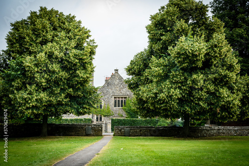 Beautiful English building set in green gardens, horizontal landscape orientation. 