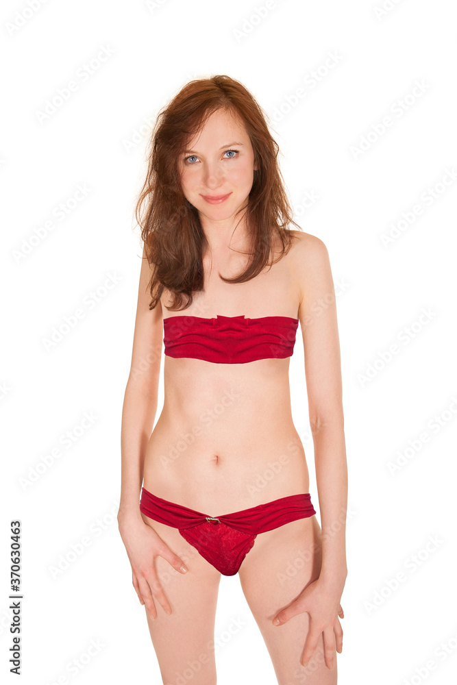 Obraz premium Beautiful young woman wearing red bandeau bra and panties, isolated on white studio background