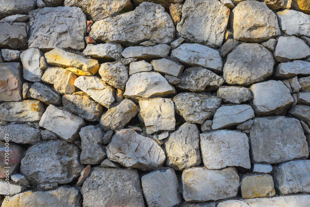 An ancient wall made of rough stones.