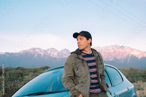 young man with jacket and cap near the mountains in the Andes mountain range