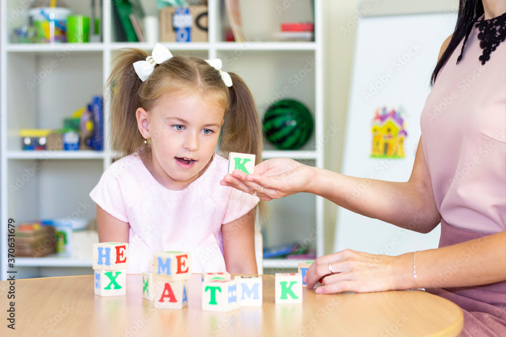 Fototapeta premium developmental and speech therapy classes with a child-girl. Speech therapy exercises and games with letters. dice game