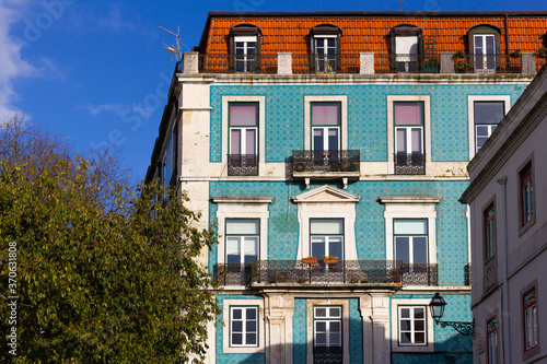 Blue tiles front facade of Lisbon building on sunny day. Traditional architecture in Portugal capital. Language translation: Graca street