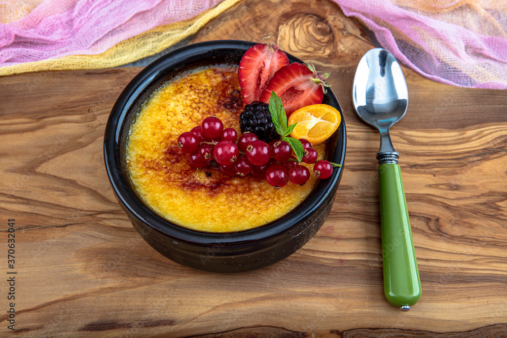 Turkish Cuisine dessert varieties. Muhallebi / Homemade Pudding. Baked rice  pudding turkish milk dessert sutlac in earthenware casserole with forest  fruits, berries, blackberries Photos | Adobe Stock