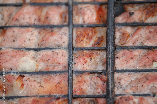 Close-up beef or pork meat barbecue prepared grilled on bbq fire flame grill, view from above