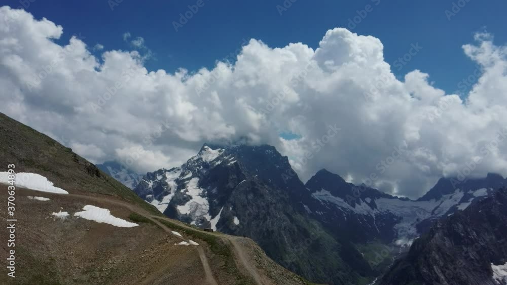 Mountain peaks in the snow on a cloudy day. Breathtaking view of Mountains. Mountain peaks in the snow on a cloudy day. Breathtaking view of Mountains.
