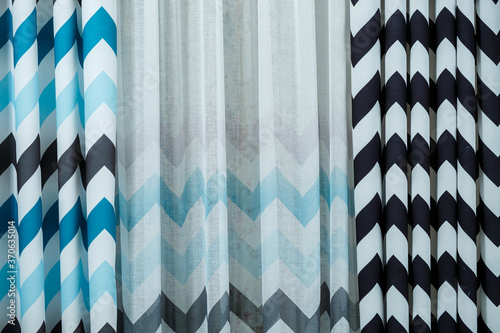 Konstfotografi Curtain samples hanging from hangers on rail in store