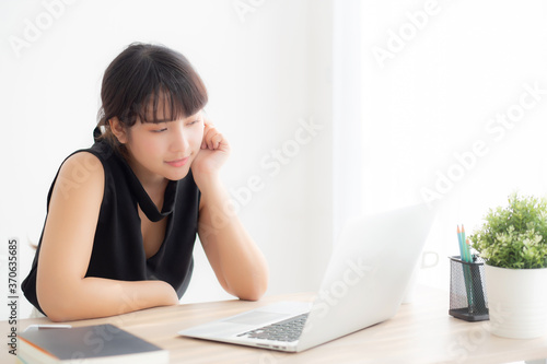 Beautiful freelance young asian woman thinking and idea working laptop computer at office, writer asia girl thoughtful inspiration writing blogging with notebook in job, business concept.