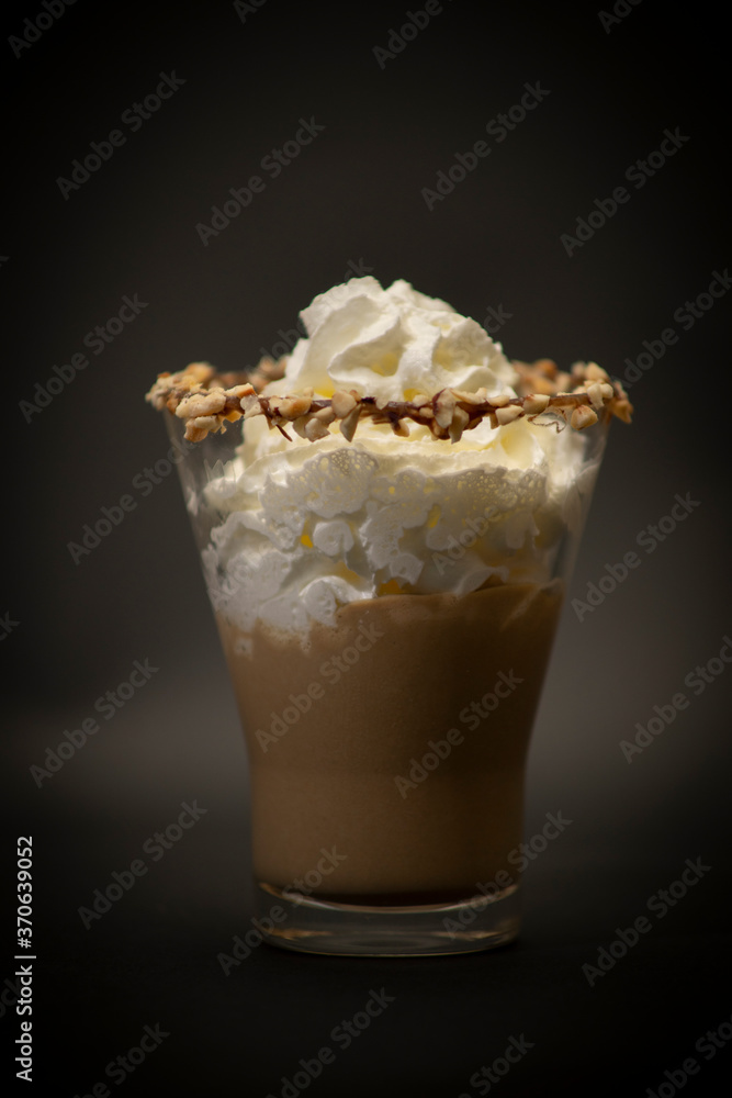 Tasty Italian hot chocolate in a big glass. Is a tasty chocolate with handmade whipped crema on top, is a n Italian ice cream with chocolate in a large fancy glass. All with a black background Tasty Italian hot chocolate in a big glass. Is a tasty chocolate with handmade whipped crema on top, is a n Italian ice cream with chocolate in a large fancy glass. All with a black background