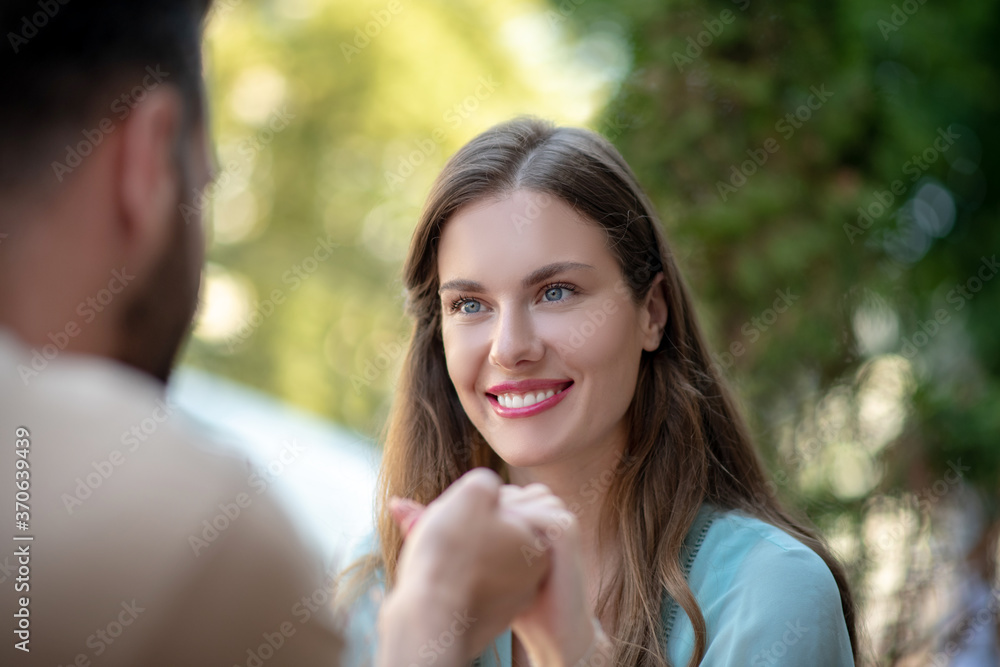 Couple looking at each other, holding hands