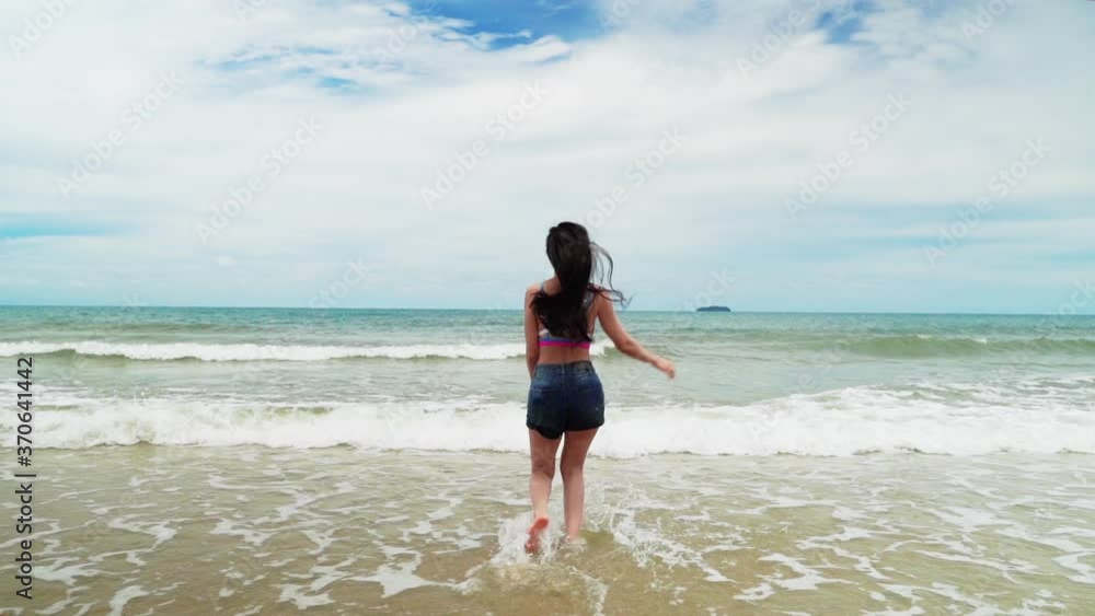 woman running into the sea, she is cheerful and fun in a summer theme atmosphere.
woman running into the sea, she is cheerful and fun in a summer theme atmosphere.