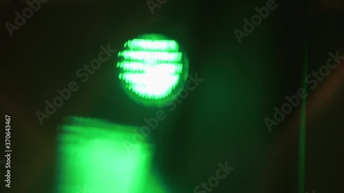 Close up of green spotlight beam flaring