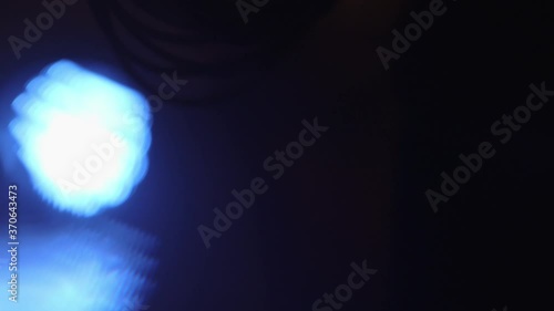 Close up of blue spotlight beam flaring