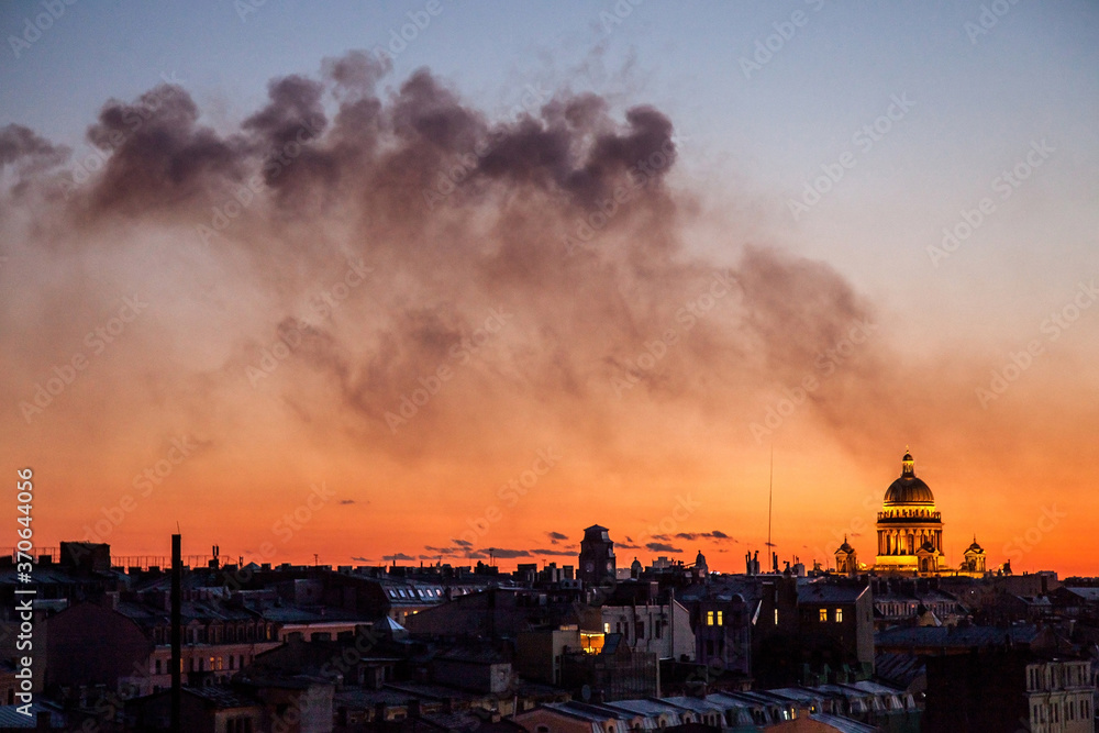 Sunset cityscape of Saint Petersburg with smoke after fireworks