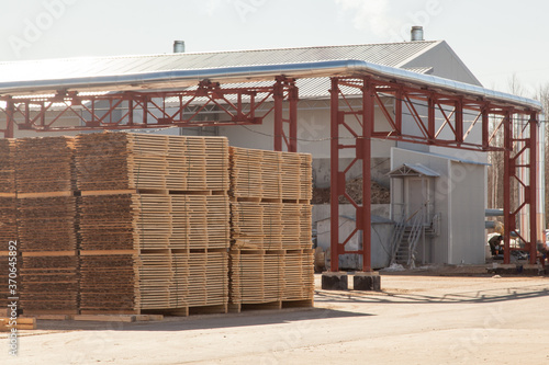 A pallet of boards in an industrial sawmill warehouse