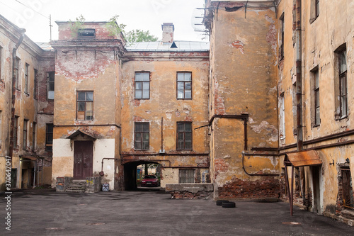 Typical Saint Petersburg courtyard wit shabby yellow walls