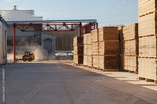 A pallet of boards in an industrial sawmill warehouse