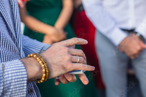 Magician showing card tricks focus in front of guests on party event wedding celebration  juggler performing show