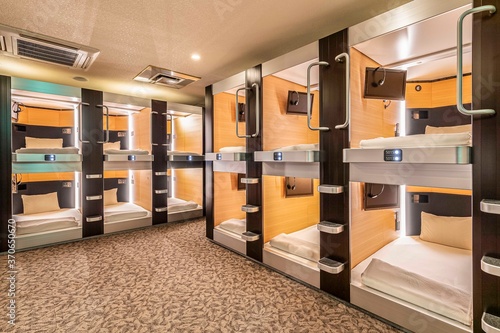 The two-story bedroom area is combined inside a modern capsule hotel in Japan photo