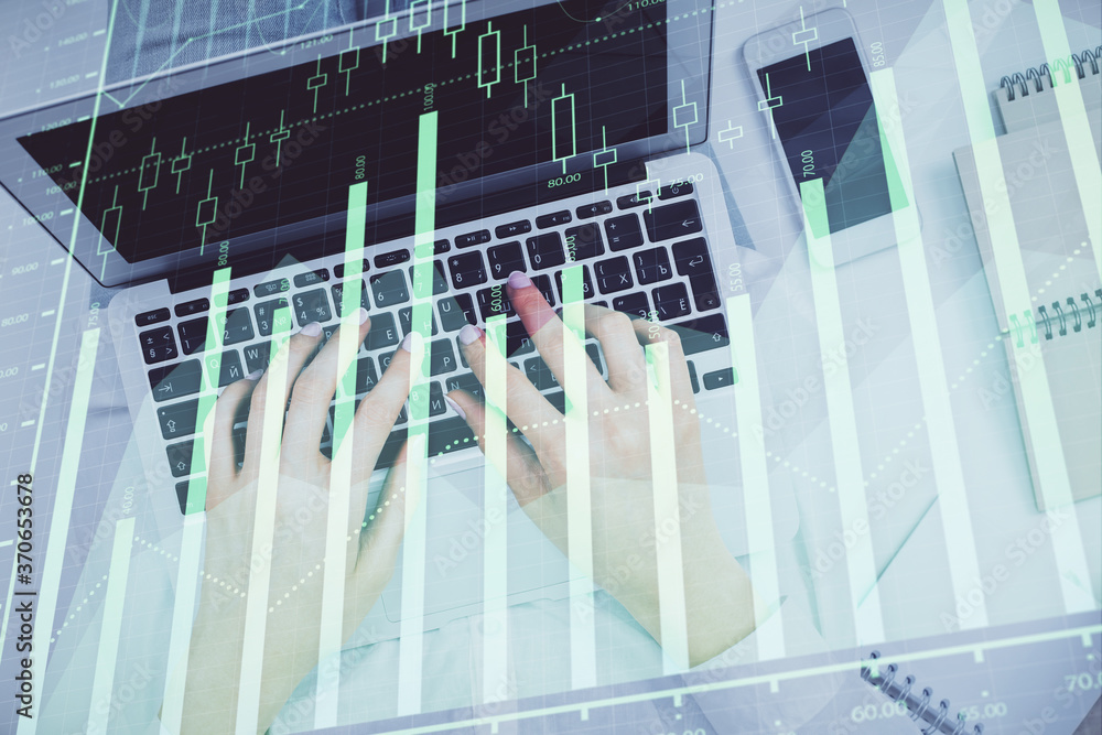 Double exposure of woman hands working on computer and forex chart hologram drawing. Top View. Financial analysis concept. Double exposure of woman hands working on computer and forex chart hologram drawing. Top View. Financial analysis concept.